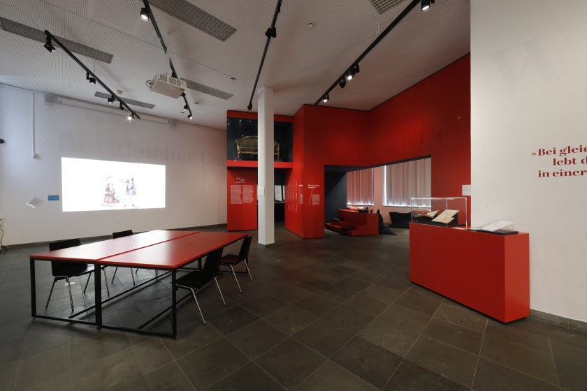 Innenansicht des Schopenhauer-Studios mit einem Besprechungstisch und Projektion an der Wand